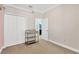 Bedroom with carpet flooring featuring closet with standard doors and view of the ensuite bathroom at 19246 Meadow Pine Dr, Tampa, FL 33647