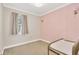Cozy bedroom with natural light, neutral carpet, and light pink wall at 19246 Meadow Pine Dr, Tampa, FL 33647