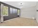 A bedroom featuring neutral carpeting, with a decorative wall, a modern light fixture, and bright, natural light at 19246 Meadow Pine Dr, Tampa, FL 33647