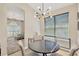Dining room with a modern chandelier, large windows, and neutral décor at 19246 Meadow Pine Dr, Tampa, FL 33647
