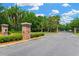 Community entrance featuring brick columns and lush landscaping for a welcoming feel at 19246 Meadow Pine Dr, Tampa, FL 33647