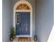 Inviting blue front door with decorative window and stylish welcome mat at 19246 Meadow Pine Dr, Tampa, FL 33647