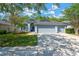 Charming single-story home featuring a three-car garage and manicured front yard at 19246 Meadow Pine Dr, Tampa, FL 33647