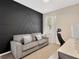 Stylish living room boasting a modern accent wall, comfortable sofa, and bright natural light at 19246 Meadow Pine Dr, Tampa, FL 33647