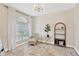 Light filled room featuring large window, neutral walls, and hardwood floor with vintage rug at 19246 Meadow Pine Dr, Tampa, FL 33647