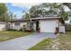 Charming home exterior featuring a driveway and an attached one-car garage at 2167 Euclid E Cir, Clearwater, FL 33764