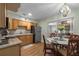 Eat-in kitchen with stainless steel appliances, wood cabinets and a dining table at 2167 Euclid E Cir, Clearwater, FL 33764