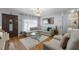 Beautifully staged living room with a leather sectional couch and hardwood floors at 2167 Euclid E Cir, Clearwater, FL 33764