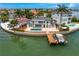 Waterfront home featuring a private pool, a large patio, boat dock, and breathtaking water views at 2250 Donato Dr, Belleair Beach, FL 33786