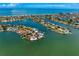 Aerial view of stunning waterfront properties with private docks in a picturesque bay community at 2250 Donato Dr, Belleair Beach, FL 33786