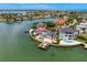 Aerial view of waterfront homes featuring a gray home with a pool and dock at 2250 Donato Dr, Belleair Beach, FL 33786