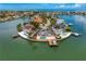Aerial view of an island neighborhood, featuring a gray home with a private pool and dock at 2250 Donato Dr, Belleair Beach, FL 33786