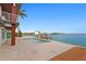 The home's backyard features a waterfront pool, private dock, and modern deck at 2250 Donato Dr, Belleair Beach, FL 33786