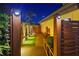Private backyard entrance with wooden walkway, garden, and fence for a secure experience at 2250 Donato Dr, Belleair Beach, FL 33786