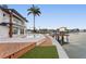 A tropical backyard featuring an in-ground swimming pool and a waterfront wood deck at 2250 Donato Dr, Belleair Beach, FL 33786