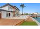The backyard features a waterfront pool, modern deck, and outdoor green space at 2250 Donato Dr, Belleair Beach, FL 33786