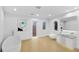 Bright bathroom featuring a modern tub, vanity, and toilet, complemented by stylish decor and natural light from arched windows at 2250 Donato Dr, Belleair Beach, FL 33786