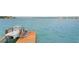 View of boat dock with a boat lift ready to go out into the open water at 2250 Donato Dr, Belleair Beach, FL 33786