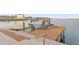 Private boat dock featuring a boat lift and seating area, providing direct access to the water at 2250 Donato Dr, Belleair Beach, FL 33786