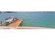 Panoramic view of a private dock with a boat lift and comfortable seating for enjoying the ocean at 2250 Donato Dr, Belleair Beach, FL 33786