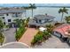 Beautiful home featuring a dark grey roof, two-car garage, and circle driveway at 2250 Donato Dr, Belleair Beach, FL 33786