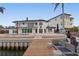 Beautiful waterfront home with a private dock, stunning pool, and outdoor entertaining space at 2250 Donato Dr, Belleair Beach, FL 33786