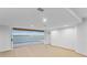 Modern living area with expansive sliding doors that provide access to a private pool and picturesque water views at 2250 Donato Dr, Belleair Beach, FL 33786