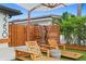 Charming outdoor seating area featuring stylish furnishings and lush landscaping, perfect for relaxing at 2250 Donato Dr, Belleair Beach, FL 33786