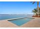 Sparkling waterfront pool featuring a modern deck and tranquil views at 2250 Donato Dr, Belleair Beach, FL 33786