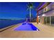 The pristine backyard pool offers breathtaking water views from the gorgeous outdoor patio at 2250 Donato Dr, Belleair Beach, FL 33786
