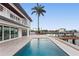 Enjoy the outdoor living in this luxury home with a swimming pool and waterfront access at 2250 Donato Dr, Belleair Beach, FL 33786