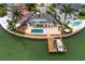 Gorgeous waterfront home featuring a pool, dock, and spacious outdoor patio with stunning water views at 2250 Donato Dr, Belleair Beach, FL 33786