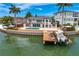 Waterfront property with a boat dock, private pool, and expansive outdoor lounging area at 2250 Donato Dr, Belleair Beach, FL 33786