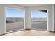 Bright room with views of the pool and waterfront through large windows at 2250 Donato Dr, Belleair Beach, FL 33786