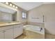 Neutral bathroom featuring a large soaking tub and a tiled shower enclosure at 2360 Sutton Pl, Spring Hill, FL 34608