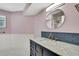 Bathroom featuring a marble sink vanity with blue subway tile and wainscotting at 2360 Sutton Pl, Spring Hill, FL 34608