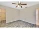 This bedroom features gray laminate floors, a ceiling fan, and a closet at 2360 Sutton Pl, Spring Hill, FL 34608