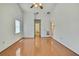Bright and airy bedroom featuring hardwood floors and an open doorway at 2360 Sutton Pl, Spring Hill, FL 34608