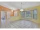 Dining area with tile flooring, decorative chandelier, and bay window, offering natural light at 2360 Sutton Pl, Spring Hill, FL 34608