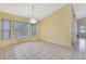 Dining area with a decorative chandelier, bay windows, and neutral wall color at 2360 Sutton Pl, Spring Hill, FL 34608