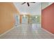 Bright foyer featuring double doors, tile flooring, and decorative lighting fixtures at 2360 Sutton Pl, Spring Hill, FL 34608
