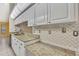 An updated kitchen shows granite countertops and sleek, patterned backsplash at 2360 Sutton Pl, Spring Hill, FL 34608
