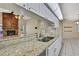 A kitchen featuring granite countertops, white cabinets, and a double sink at 2360 Sutton Pl, Spring Hill, FL 34608