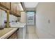 Bright laundry room featuring tile floors, a window, and washer and dryer at 2360 Sutton Pl, Spring Hill, FL 34608
