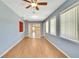 A bright living room showcases wood flooring and large windows at 2360 Sutton Pl, Spring Hill, FL 34608