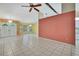 Spacious living area showcasing tile floors, a ceiling fan, and a bright and airy ambiance at 2360 Sutton Pl, Spring Hill, FL 34608