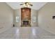 Living room featuring a stone fireplace, vaulted ceilings, and neutral-toned walls at 2360 Sutton Pl, Spring Hill, FL 34608