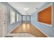 A bright and airy living room features hardwood floors and large windows at 2360 Sutton Pl, Spring Hill, FL 34608