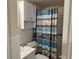 A clean bathroom with vanity storage, standard toilet, and shower-tub combo with floral curtain at 2434 Australia E Way # 22, Clearwater, FL 33763