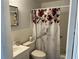 Bathroom featuring vanity with storage and floral curtain, along with essential bath products on the toilet at 2434 Australia E Way # 22, Clearwater, FL 33763